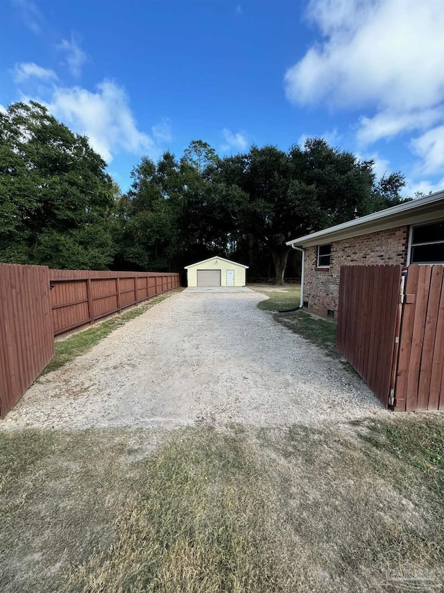 view of yard featuring an outbuilding and a garage