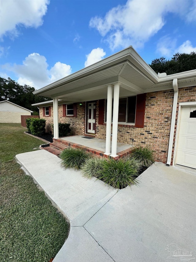 exterior space with a porch and a garage