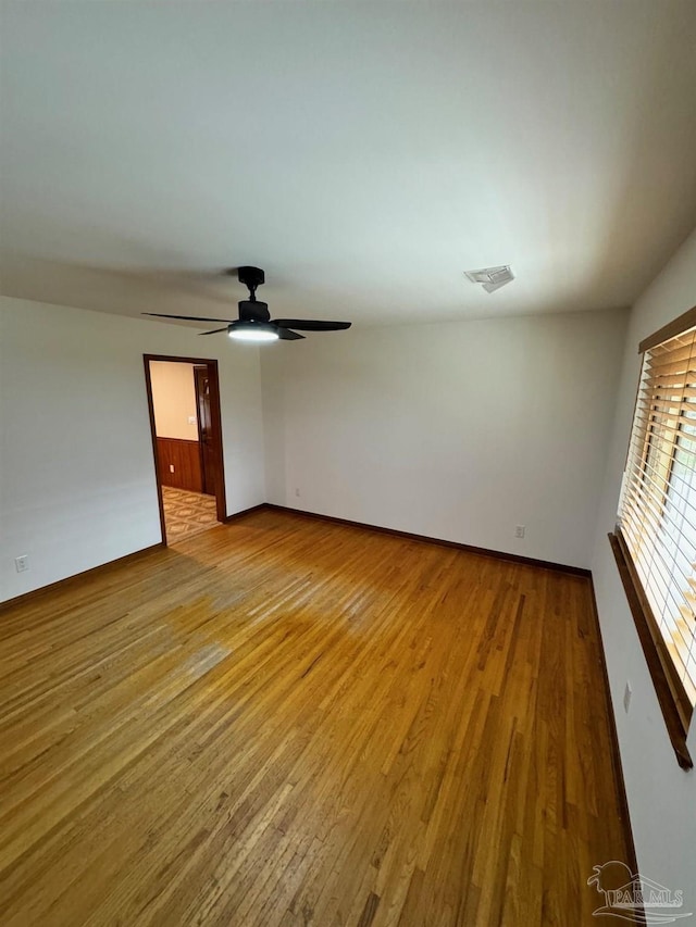 7920 Reeders Ln, Pensacola, FL 32526 - spare room with wood finished floors, ceiling fan, and baseboards