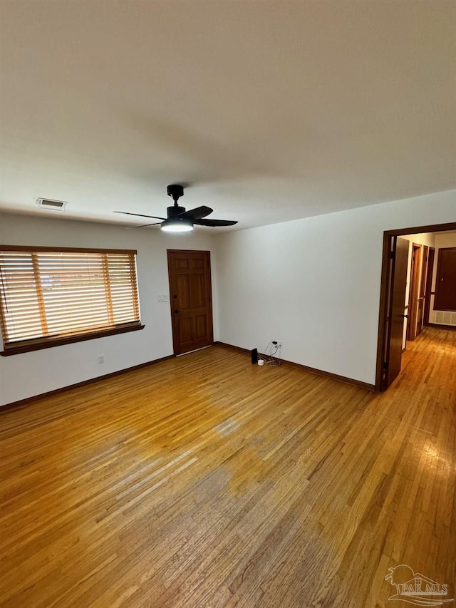7920 Reeders Ln, Pensacola, FL 32526 - unfurnished living room featuring light wood-style floors, a ceiling fan, and baseboards