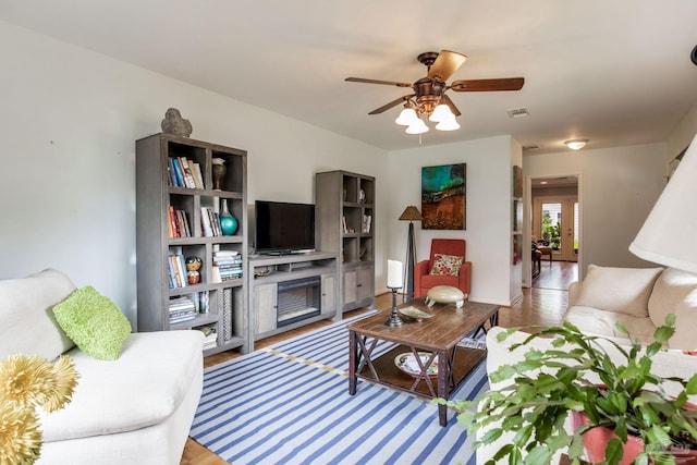 6031 Keating Rd, Pensacola, FL 32504 - living room with a ceiling fan, a fireplace, and light wood-type flooring