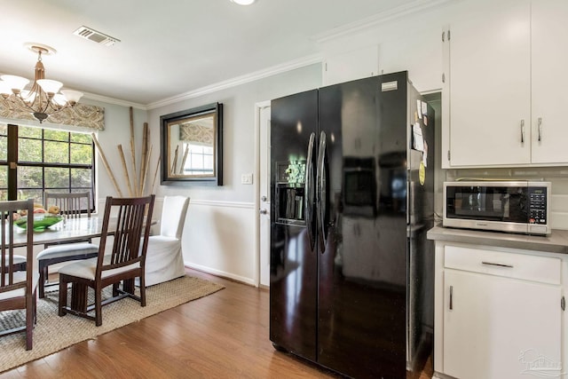 6031 Keating Rd, Pensacola, FL 32504 - dining room with a chandelier, wood finished floors, and ornamental molding