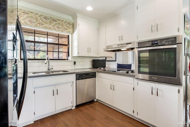 6031 Keating Rd, Pensacola, FL 32504 - kitchen featuring stainless steel appliances, crown molding, dark wood-style flooring, under cabinet range hood, and white cabinetry