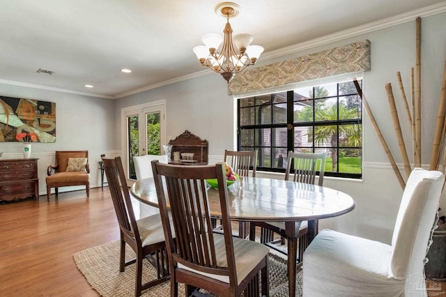 6031 Keating Rd, Pensacola, FL 32504 - dining area featuring light wood finished floors, healthy amount of natural light, a chandelier, crown molding, and french doors