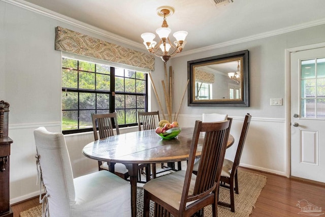 6031 Keating Rd, Pensacola, FL 32504 - dining space with a chandelier, ornamental molding, and wood finished floors