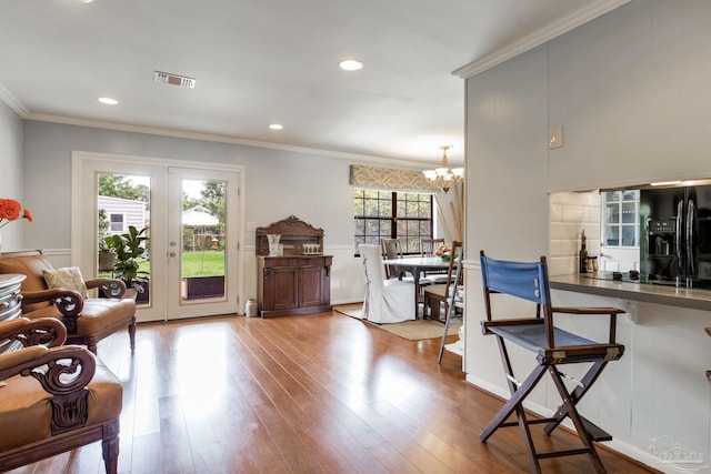 6031 Keating Rd, Pensacola, FL 32504 - living area featuring a chandelier, wood finished floors, crown molding, and recessed lighting