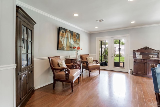 6031 Keating Rd, Pensacola, FL 32504 - sitting room with wood finished floors, french doors, crown molding, and recessed lighting