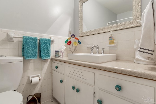 6031 Keating Rd, Pensacola, FL 32504 - bathroom with tile walls, vanity, and wainscoting