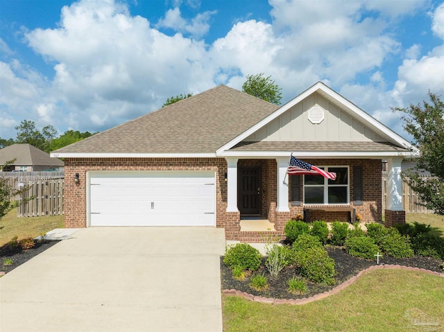 view of front of home with board and batten siding, driveway, brick siding, fence, and an attached garage