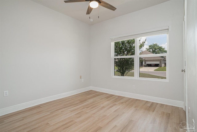 unfurnished room with baseboards, a ceiling fan, and light wood finished floors