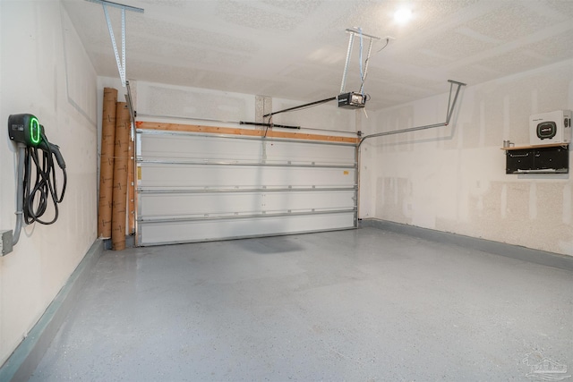 garage with baseboards and a garage door opener