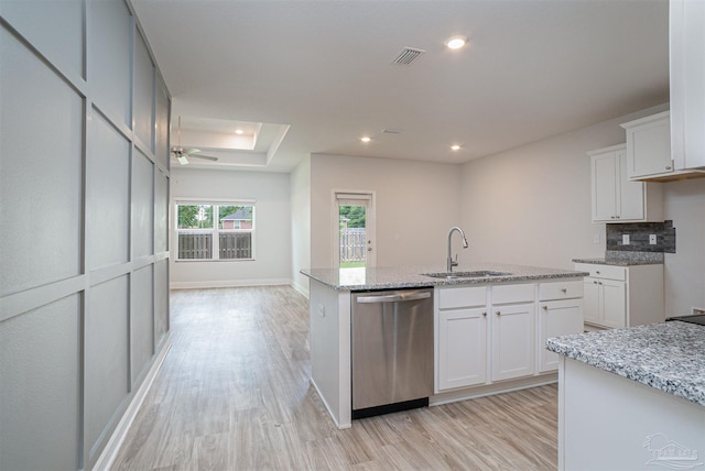 kitchen with a sink, a center island with sink, light wood finished floors, and dishwasher