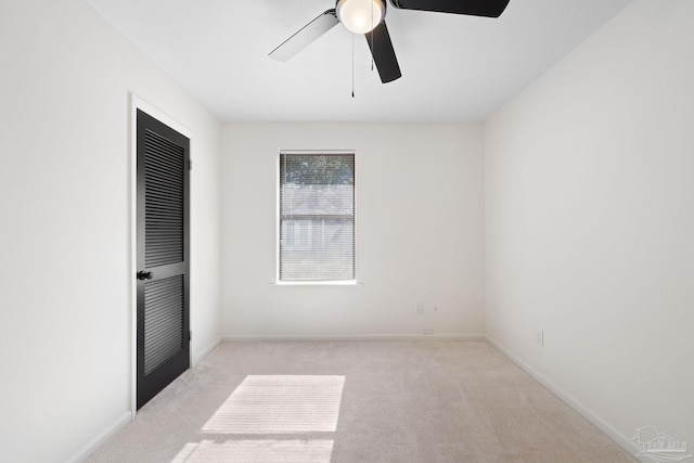 unfurnished bedroom featuring light carpet and ceiling fan