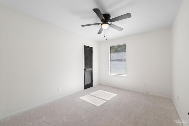 carpeted empty room featuring ceiling fan