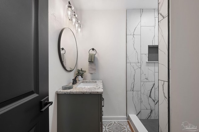 bathroom featuring vanity and tiled shower