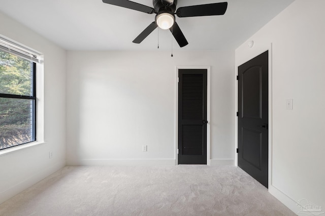 carpeted empty room with ceiling fan