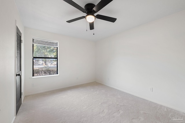 carpeted empty room with ceiling fan