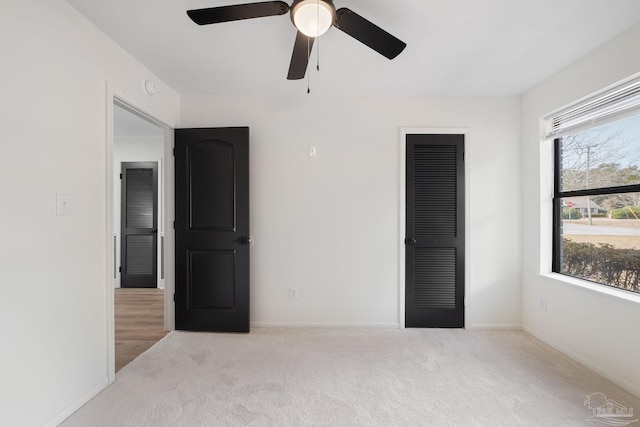 unfurnished room featuring light colored carpet