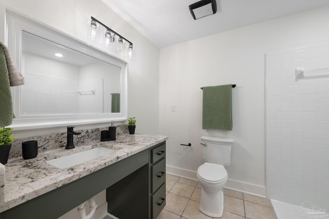 bathroom featuring vanity, a shower, tile patterned floors, and toilet