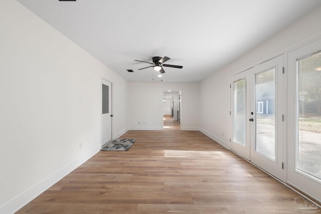 spare room with french doors, ceiling fan, and light hardwood / wood-style flooring