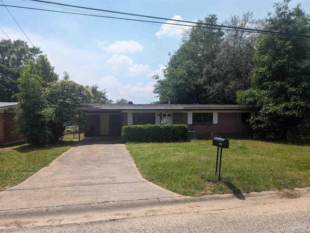 ranch-style house featuring concrete driveway, brick siding, and a front yard