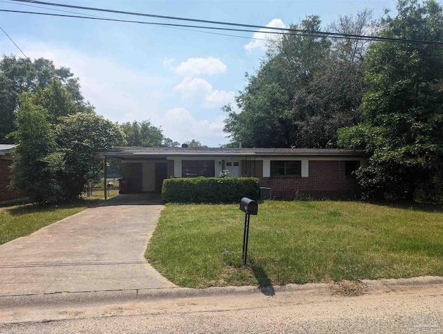 ranch-style house with brick siding, concrete driveway, a front lawn, and an attached carport