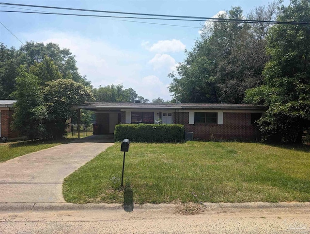 ranch-style house featuring a carport, concrete driveway, brick siding, and a front lawn