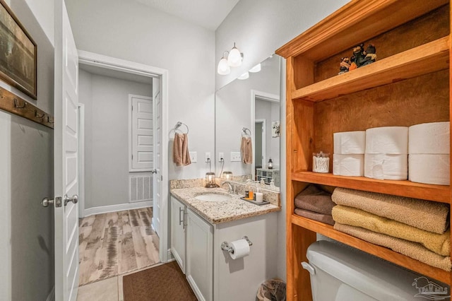 8056 Stream Ridge Rd, Pensacola, FL 32526 - half bath with vanity, toilet, wood finished floors, and baseboards