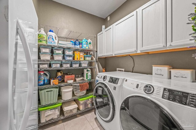 8056 Stream Ridge Rd, Pensacola, FL 32526 - laundry area featuring washer and clothes dryer, cabinet space, and tile patterned flooring