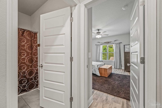 8056 Stream Ridge Rd, Pensacola, FL 32526 - hall featuring a textured ceiling and light wood-type flooring