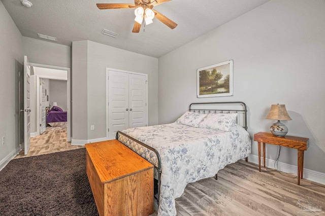 8056 Stream Ridge Rd, Pensacola, FL 32526 - bedroom featuring baseboards, a closet, wood finished floors, ceiling fan, and a textured ceiling