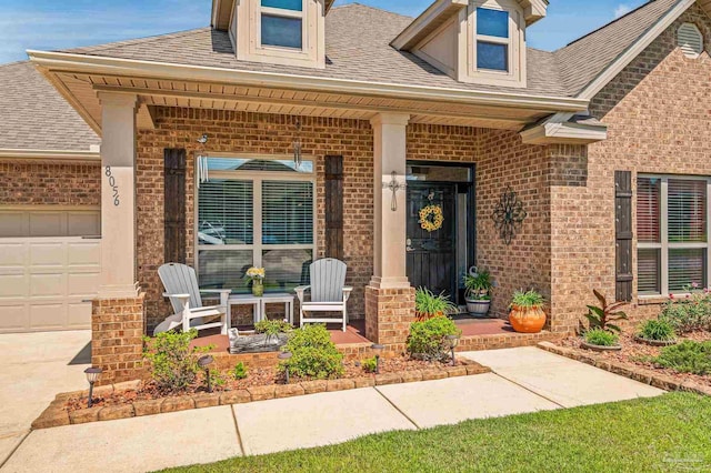 8056 Stream Ridge Rd, Pensacola, FL 32526 - view of exterior entry with brick siding, a porch, and a garage