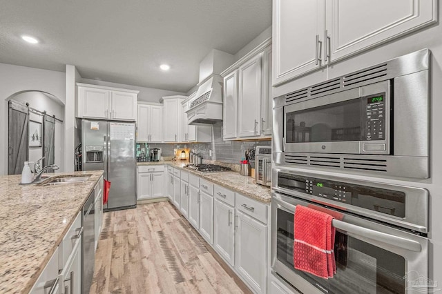 8056 Stream Ridge Rd, Pensacola, FL 32526 - kitchen with stainless steel appliances, a sink, white cabinetry, light wood-style floors, and recessed lighting