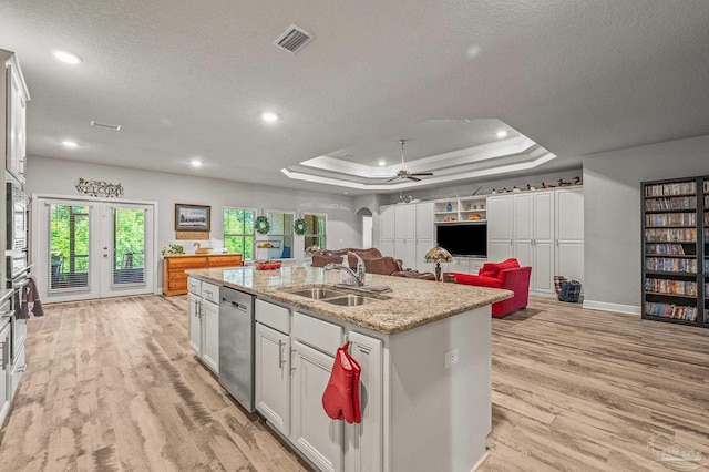 8056 Stream Ridge Rd, Pensacola, FL 32526 - kitchen featuring dishwasher, light wood-style flooring, an island with sink, a textured ceiling, and a sink