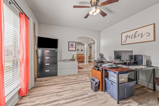 8056 Stream Ridge Rd, Pensacola, FL 32526 - home office featuring arched walkways, light wood finished floors, a ceiling fan, and baseboards