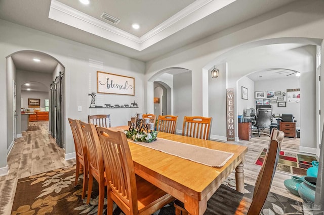 8056 Stream Ridge Rd, Pensacola, FL 32526 - dining room featuring crown molding, wood finished floors, baseboards, an office area, and a raised ceiling