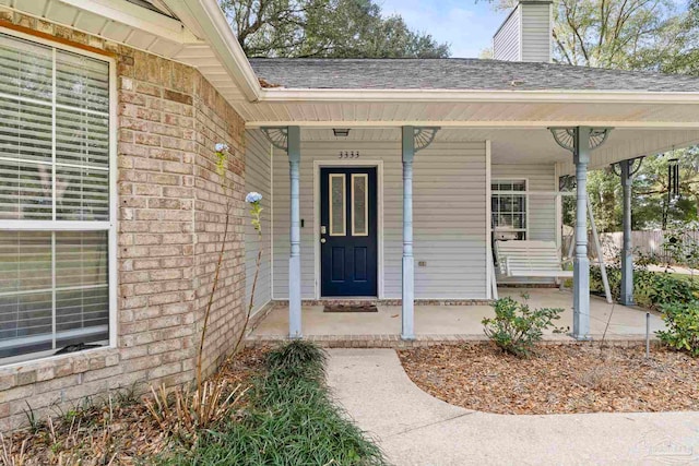 view of exterior entry with covered porch