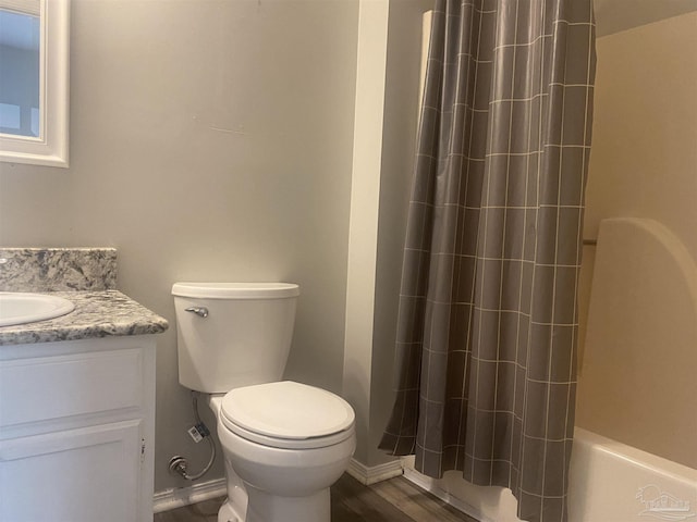 full bathroom with hardwood / wood-style flooring, vanity, toilet, and shower / tub combo