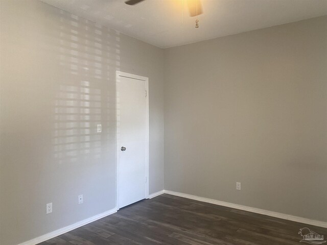 spare room featuring ceiling fan and dark hardwood / wood-style floors