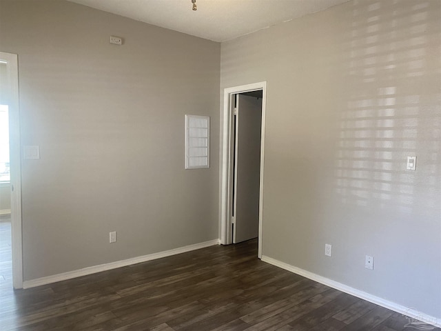 spare room featuring dark hardwood / wood-style flooring