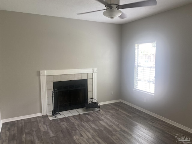 unfurnished living room featuring ceiling fan, hardwood / wood-style floors, and a tile fireplace