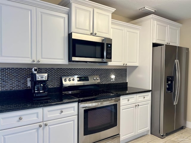 1792 Galvez Dr, Gulf Breeze, FL 32563 - kitchen featuring white cabinetry, appliances with stainless steel finishes, and decorative backsplash
