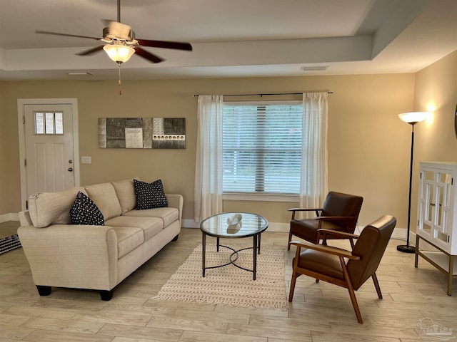 1792 Galvez Dr, Gulf Breeze, FL 32563 - living room featuring a tray ceiling, light hardwood / wood-style flooring, and ceiling fan