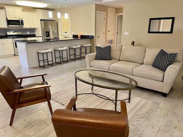 1792 Galvez Dr, Gulf Breeze, FL 32563 - living room featuring sink and light hardwood / wood-style flooring