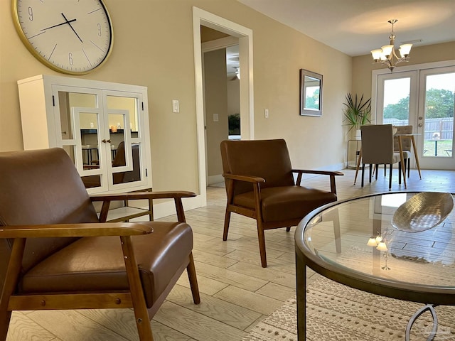 1792 Galvez Dr, Gulf Breeze, FL 32563 - sitting room featuring french doors, an inviting chandelier, and light hardwood / wood-style flooring