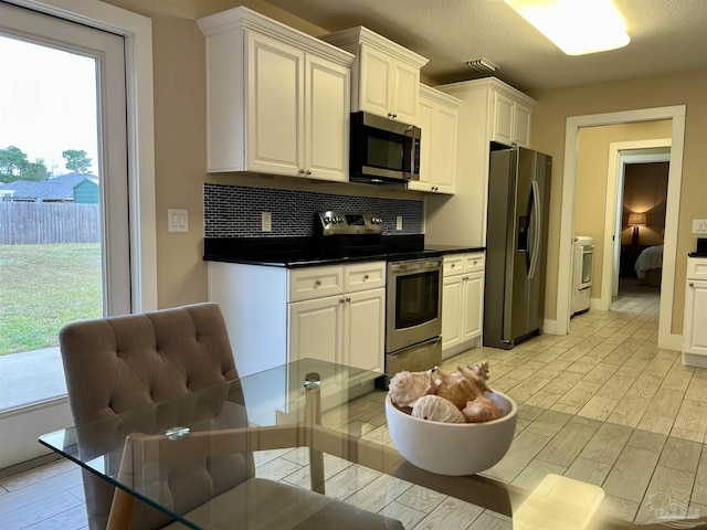1792 Galvez Dr, Gulf Breeze, FL 32563 - kitchen with white cabinetry, appliances with stainless steel finishes, and tasteful backsplash