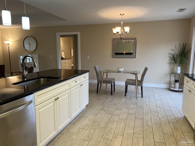 1792 Galvez Dr, Gulf Breeze, FL 32563 - kitchen with white cabinetry, sink, hanging light fixtures, and dishwasher