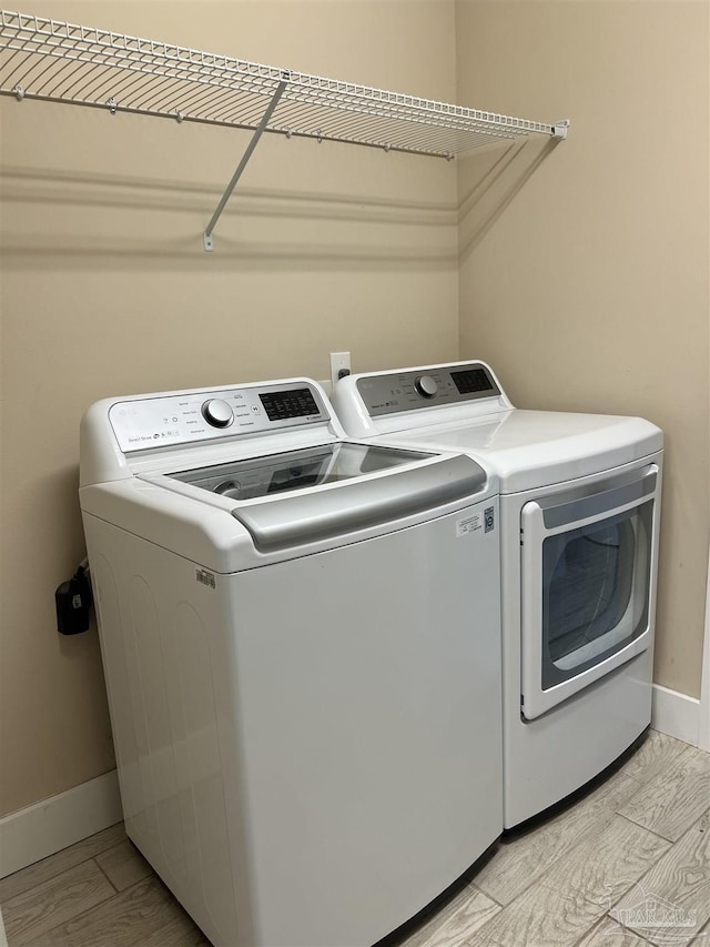 1792 Galvez Dr, Gulf Breeze, FL 32563 - washroom featuring independent washer and dryer and light hardwood / wood-style floors