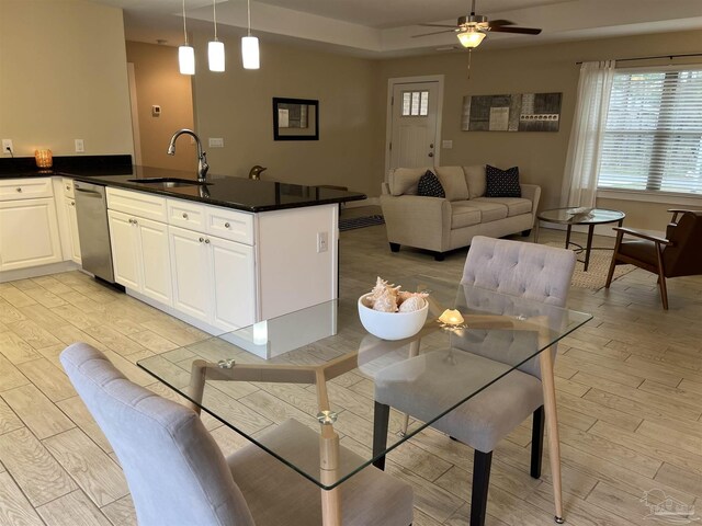 1792 Galvez Dr, Gulf Breeze, FL 32563 - kitchen with pendant lighting, kitchen peninsula, sink, and white cabinets