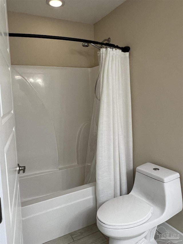 1792 Galvez Dr, Gulf Breeze, FL 32563 - bathroom featuring toilet, shower / tub combo, and hardwood / wood-style floors